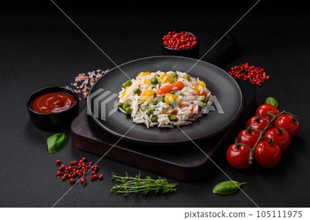 Delicious fresh white boiled rice with vegetables carrots, peppers and asparagus beans on a ceramic plate Delicious fresh white boiled rice with vegetables carrots, peppers and asparagus beans on a ceramic plate 105111975