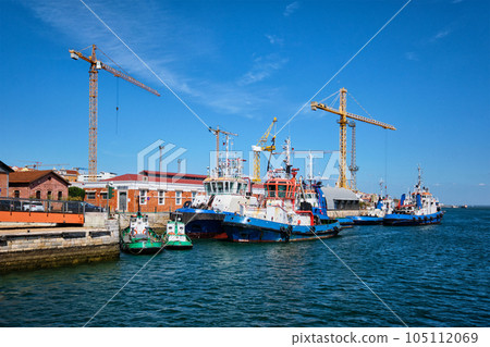 Port of Lisbon with moored tugboats on sunny day. Tagus river, Lisbon, Portugal 105112069