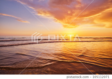 Atlantic ocean sunset with surging waves at Fonte da Telha beach, Costa da Caparica, Portugal 105112071