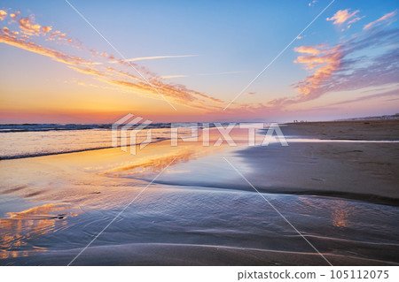 Atlantic ocean after sunset with surging waves at Fonte da Telha beach, Costa da Caparica, Portugal Atlantic ocean after sunset with surging waves at Fonte da Telha beach, Costa da Caparica, Portugal 105112075