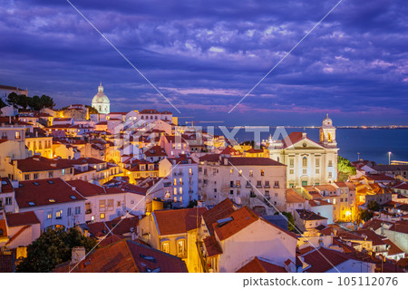 View of Lisbon famous view from Miradouro de Santa Luzia tourist viewpoint over Alfama old city district at night. Lisbon, Portugal. View of Lisbon famous view from Miradouro de Santa Luzia tourist viewpoint over Alfama old city district at night. Lisbon, Portugal. 105112076