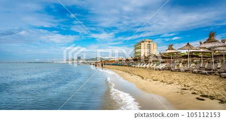 Golem, Durres, ALBANIA. Beach shoreline with sun umbrellas made from straw. A blue sky on the Adriatic Sea. Golem, Durres, ALBANIA. Beach shoreline with sun umbrellas made from straw. A blue sky on the Adriatic Sea. 105112153