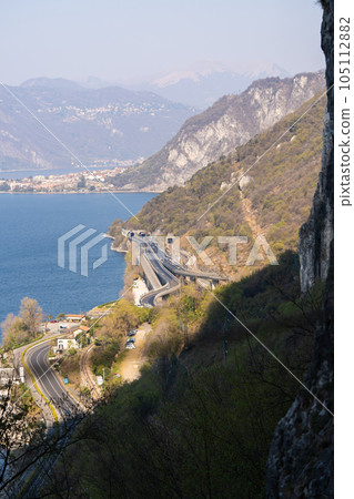 Aerial view of mountain road and tunnel in forest in summer at Como lake Aerial view of mountain road and tunnel in forest in summer at Como lake 105112882