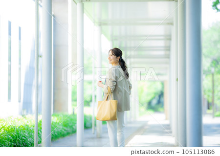 Office casual woman walking outdoors 105113086