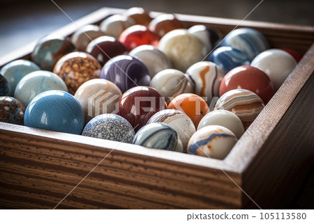 close-up of a marble collection in a wooden box, created with generative ai 105113580