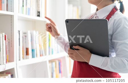 woman working in a bookstore woman working in a bookstore 105117205