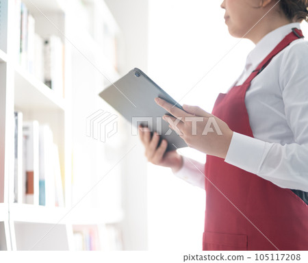 woman working in a bookstore woman working in a bookstore 105117208