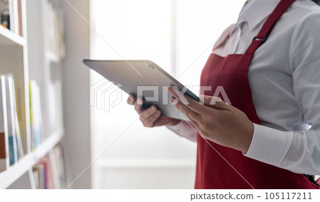 woman working in a bookstore woman working in a bookstore 105117211