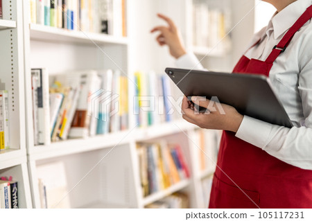 woman working in a bookstore woman working in a bookstore 105117231