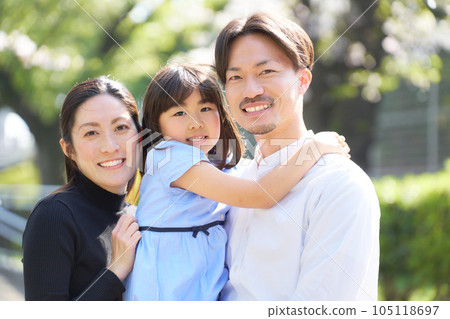 A family of three looking at you with a smile 105118697