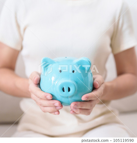 Money Saving for Future Plan, Retirement fund, Pension, Investment, Wealth Business and Financial concepts. hand holding and putting into piggy bank, Money Counting for World Savings day and Donate Money Saving for Future Plan, Retirement fund, Pension, Investment, Wealth Business and Financial concepts. hand holding and putting into piggy bank, Money Counting for World Savings day and Donate 105119590