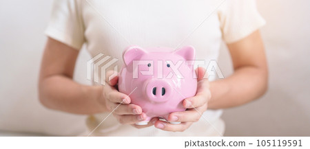 Money Saving for Future Plan, Retirement fund, Pension, Investment, Wealth Business and Financial concepts. hand holding and putting into piggy bank, Money Counting for World Savings day and Donate Money Saving for Future Plan, Retirement fund, Pension, Investment, Wealth Business and Financial concepts. hand holding and putting into piggy bank, Money Counting for World Savings day and Donate 105119591