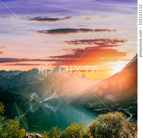 Tatra National Park, Poland. Famous Mountains Lake Morskie Oko Or Sea Eye Lake In Summer Evening. Beautiful Sunset Sun Sunshine Sunrays Above Tatras Lake Landscape 105121112