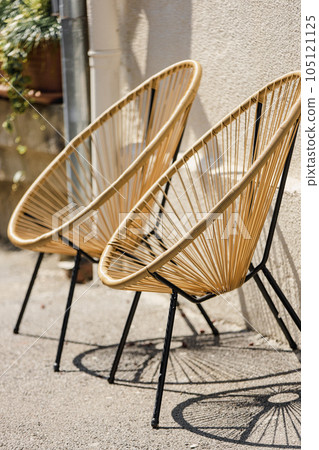 Cafe Furniture. Trendy Designer Chairs. Rattan Wicker Chair. Wicker Armchairs Stand Outside. Modern Furniture At Street. Fashion Designer Armchairs. Interior Of Summer Cafe. Comfortable Trendy Cafe Furniture. Trendy Designer Chairs. Rattan Wicker Chair. Wicker Armchairs Stand Outside. Modern Furniture At Street. Fashion Designer Armchairs. Interior Of Summer Cafe. Comfortable Trendy 105121125