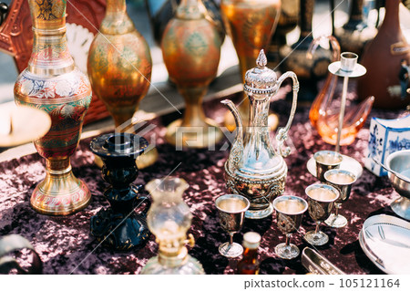 Metal Oriental Jug With Engraved Texture Floral Pattern. Oriental Style Ancient Jug At Flea Market. East Tableware. Old Tableware For Cofe And Tea 105121164
