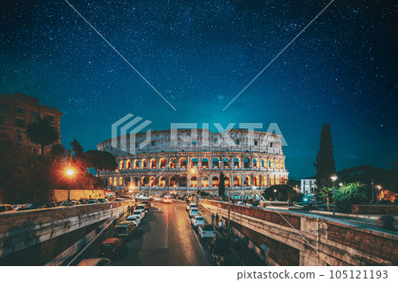 Rome, Italy. Bold Bright Blue Azure Night Starry Sky With Glowing Stars Above Colosseum Also Known As Flavian Amphitheatre In Evening Or Night Time. Travel To Italy Rome, Italy. Bold Bright Blue Azure Night Starry Sky With Glowing Stars Above Colosseum Also Known As Flavian Amphitheatre In Evening Or Night Time. Travel To Italy 105121193