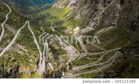 Trollstigen, Andalsnes, Norway. Cars Goes On Serpentine Mountain Road Trollstigen. Famous Norwegian Landmark And Popular Destination. Norwegian County Road 63 In Summer Day. 105121195