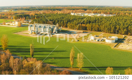 Aerial View Modern Granary, Grain-drying Complex, Commercial Grain Or Seed Silos In Rural Landscape. Corn Dryer, Inland Grain Terminal, Grain Elevators In Field 4K. Biogas Plant Or Bioreactor For 105121202