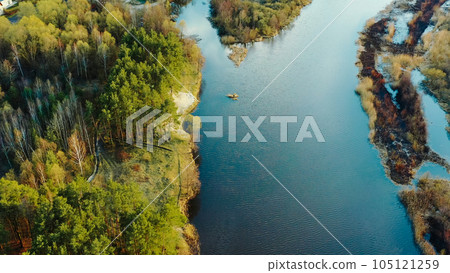 Aerial View Curved River In Early Spring Landscape. River bends and pine forest landscape. Top View Of Beautiful European Nature From High Attitude. Drone View. Bird's Eye View 105121259