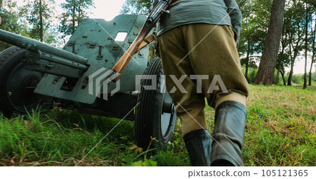 Group Of Re-enactors Dressed As Russian Soviet Red Army Infantry Soldiers Of World War Ii Are Move Soviet 45mm Anti-tank Gun To Combat Position. Preparing For Combat Historical Reenactment 105121365