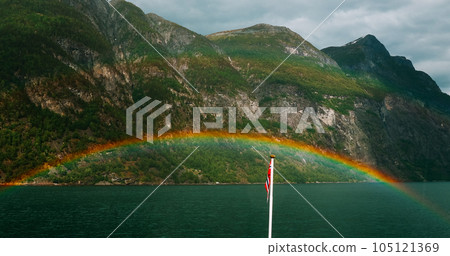 Sunnylvsfjorden, Norway. Colorful Rainbow Above Sunnylvsfjorden Spring Landscape. Panorama View From Floating Touristic Ship Ferry Boat In Summer Day. Famous Norwegian Landmark And Popular Destination Sunnylvsfjorden, Norway. Colorful Rainbow Above Sunnylvsfjorden Spring Landscape. Panorama View From Floating Touristic Ship Ferry Boat In Summer Day. Famous Norwegian Landmark And Popular Destination 105121369