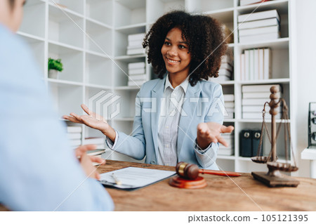 Portrait of african american woman lawyer studying lawsuit a for a discussing client documents law data before going to court 105121395
