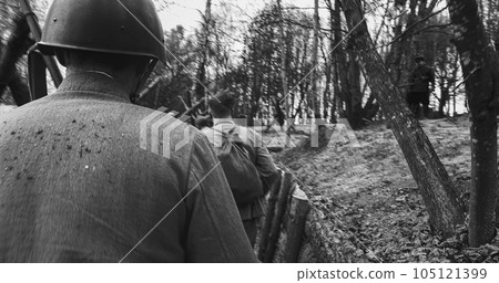 Re-enactors Dressed As Soviet Russian Soldiers take up fighting positions in trenches. Position Defense. Soldiers Aiming With Rifles. Reconstruction Of Battles World War Ii. Black And White 105121399
