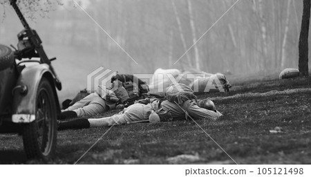Re-enactor Dressed As Soviet Russian Soldier Lies Slain In Reconstruction Of Battles World War I Near Combat Sidecar. Soviet Russian Infantry Soldier In World War Ii. Black And White 105121498