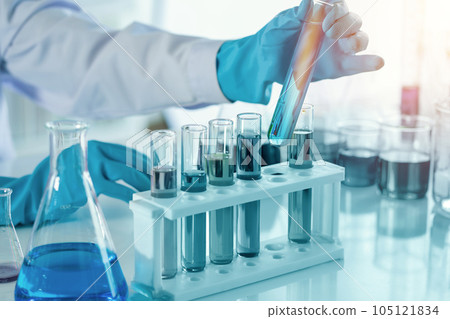 scientist with equipment and science experiments, laboratory glassware containing chemical liquid for research or analyzing a sample into test tube in laboratory scientist with equipment and science experiments, laboratory glassware containing chemical liquid for research or analyzing a sample into test tube in laboratory 105121834