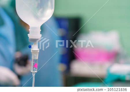 Normal saline solution or sodium chloride with infusion bottle drip for patient in hospital, Intravenous system of operating surgeons 105121836