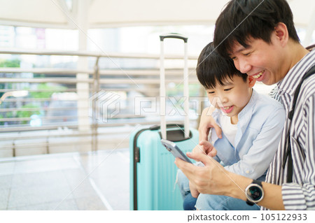 Man and son traveling in city. 105122933