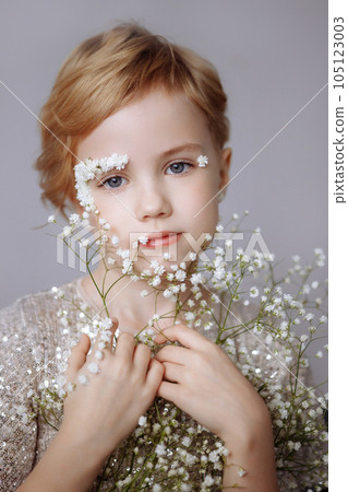 Portrait of a beautiful blondie child with perfect skin and creative floral makeup. 105123003