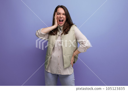 happy cute young brunette woman rejoices in victory 105123835