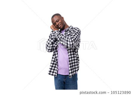 portrait of a handsome 30 year old african guy dressed in a plaid shirt against the background with 105123890