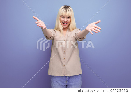 portrait of a pretty blonde european young woman stretching out her arms for a hug portrait of a pretty blonde european young woman stretching out her arms for a hug 105123910