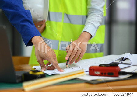 Cropped image of architects team working on project ,collaborating, planning working together in meeting room 105124944