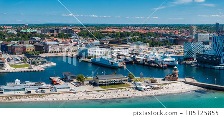 View of the Helsinborg city centre and the port of Helsingborg in Sweden. Old town by the beach and city port in Helsingborg harbour. Beautiful aerial view. View of the Helsinborg city centre and the port of Helsingborg in Sweden. Old town by the beach and city port in Helsingborg harbour. Beautiful aerial view. 105125855