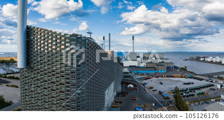 Amager Bakke, Amager Hill or Amager Slope or Copenhill - a heat and power waste-to-energy plant and a sports park in Amager, Copenhagen, Denmark. ESG green energy. Amager Bakke, Amager Hill or Amager Slope or Copenhill - a heat and power waste-to-energy plant and a sports park in Amager, Copenhagen, Denmark. ESG green energy. 105126176