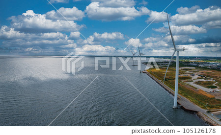 Aerial view of the wind turbines. Green ecological power energy generation. Wind farm eco field. Offshore and onshore windmill farm green energy at sea. Offshore wind turbines on the coast of Copenhag Aerial view of the wind turbines. Green ecological power energy generation. Wind farm eco field. Offshore and onshore windmill farm green energy at sea. Offshore wind turbines on the coast of Copenhag 105126178