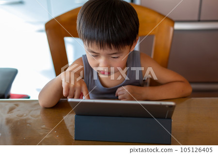 Boys playing on a tablet Boys playing on a tablet 105126405