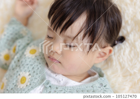 Kid taking a nap 105127470