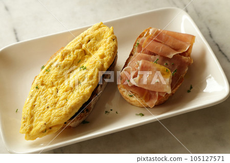 Breakfast set. Delicious sandwich - omelette and smoked ham with honey  on toasted bread. 105127571