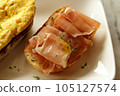 Breakfast dish. Open-Faced Sandwich  - Smoked ham with honey on toasted bread. 105127574