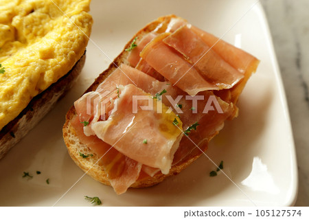 Breakfast dish. Open-Faced Sandwich - Smoked ham with honey on toasted bread. Breakfast dish. Open-Faced Sandwich - Smoked ham with honey on toasted bread. 105127574