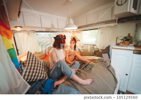 Portrait of a cute lesbian couple. Two girls spend time tenderly together in a camper trailer. Love and attitude. LGBT concept Portrait of a cute lesbian couple. Two girls spend time tenderly together in a camper trailer. Love and attitude. LGBT concept 105129560