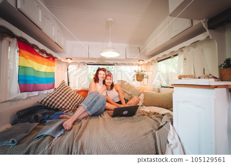 Portrait of a cute lesbian couple. Two girls spend time tenderly together in a camper trailer. Love and attitude. LGBT concept 105129561
