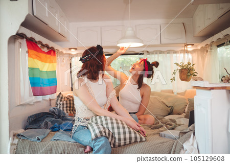 Portrait of a cute lesbian couple. Two girls spend time tenderly together in a camper trailer. Love and attitude. LGBT concept 105129608