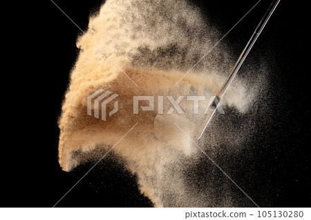 Golf ball tee explode from sand bunker. Golfer hit ball with club to sand explosion to green. Golf club hit ball tee in sand wedge bunker explosion. Black background isolated freeze motion Golf ball tee explode from sand bunker. Golfer hit ball with club to sand explosion to green. Golf club hit ball tee in sand wedge bunker explosion. Black background isolated freeze motion 105130280
