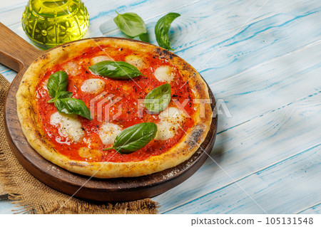 Margarita pizza with tomatoes, mozzarella cheese and basil Margarita pizza with tomatoes, mozzarella cheese and basil 105131548