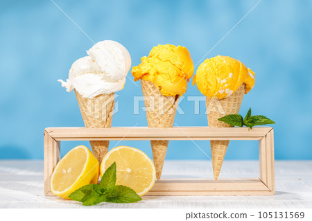 Refreshing ice cream in waffle cones with lemon flavour Refreshing ice cream in waffle cones with lemon flavour 105131569